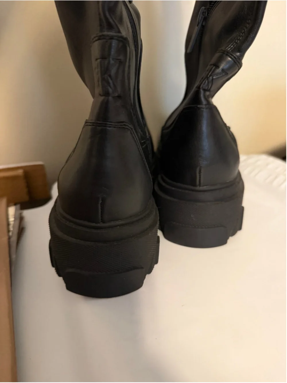 Calvin Klein black chunky platform boots featuring a thick, ridged lug sole.